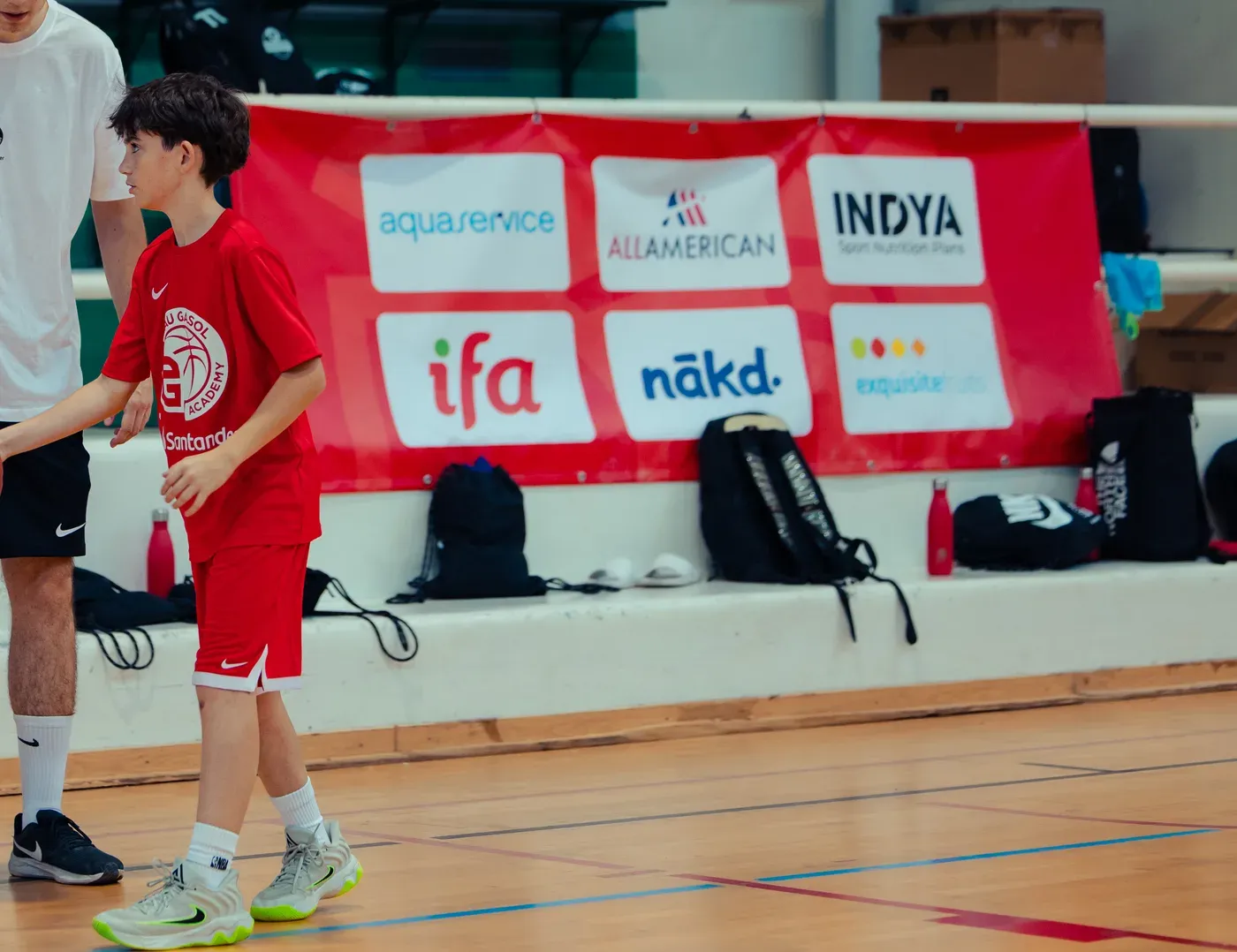 On-court action in front of the Exquisite Fruits sponsor banner